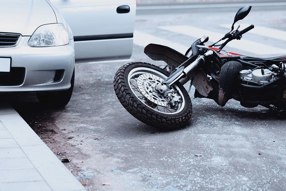 Motorcycle crashes into car